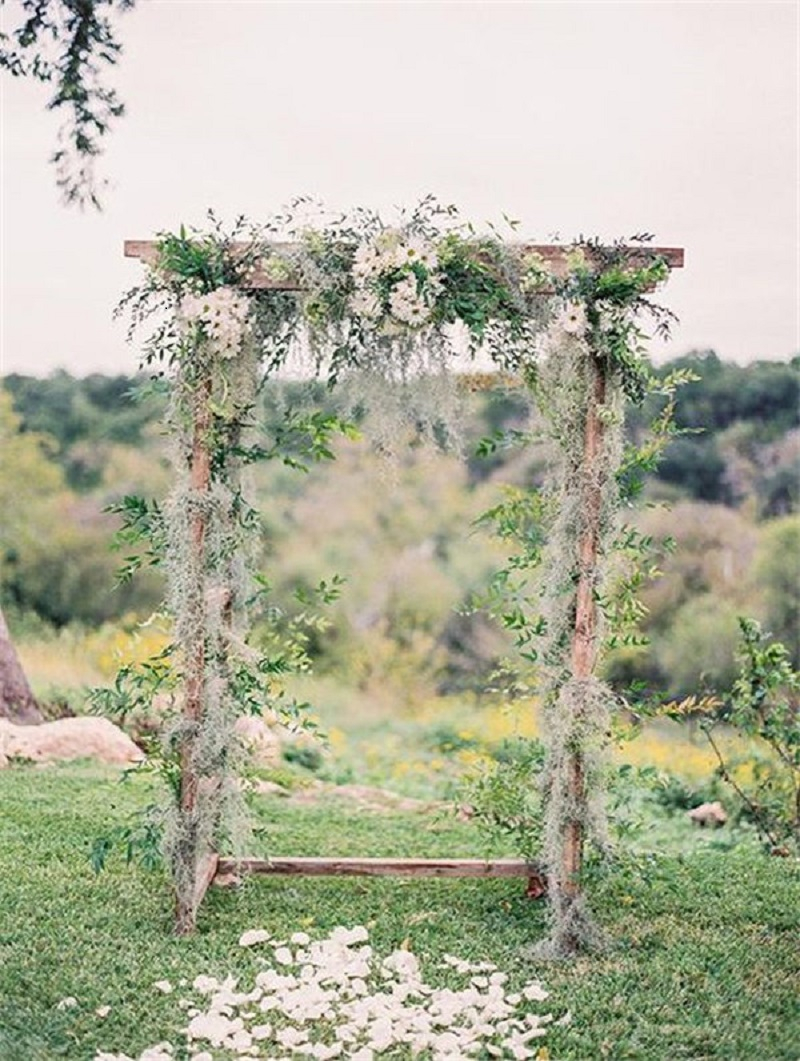 Bohemian wedding arbor with daisies arch