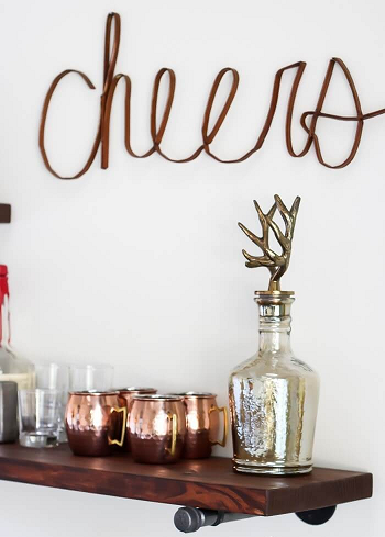 Minimalist floating bar shelves with iron pipe brackets Uncomplicated DIY Pipe Shelves To Save Space Efficiently