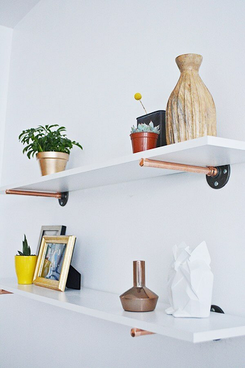 Simple copper pipe and white wood floating shelves Uncomplicated DIY Pipe Shelves To Save Space Efficiently