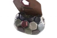 Soccer ball into hand bag